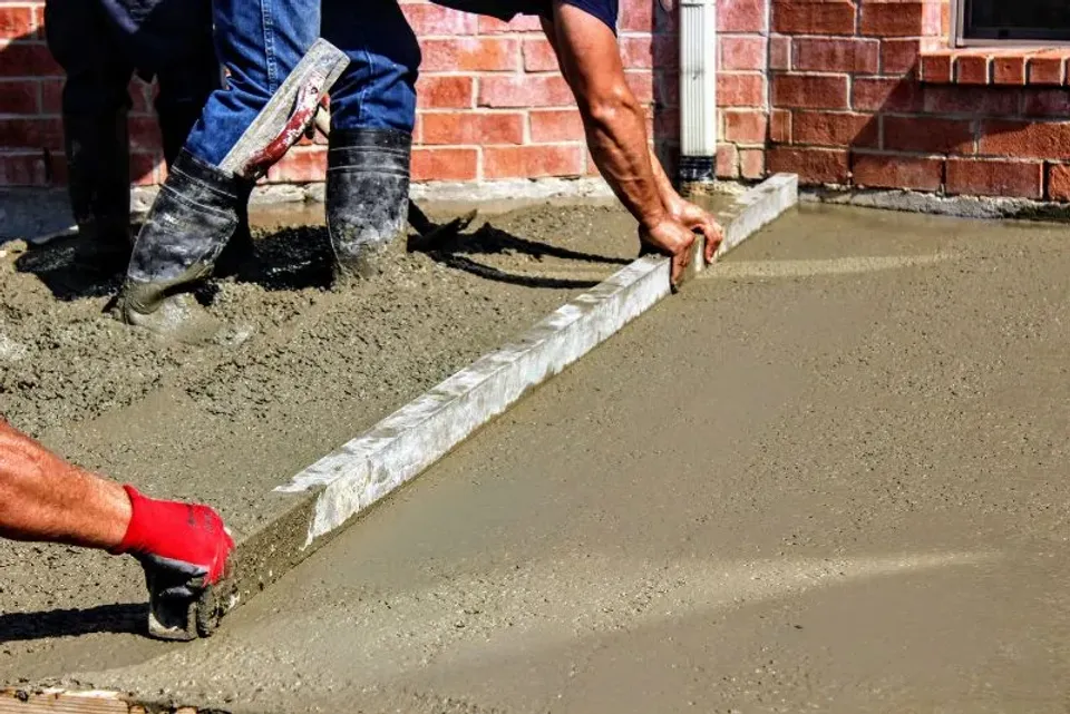 concrete worker levelling concrete slab